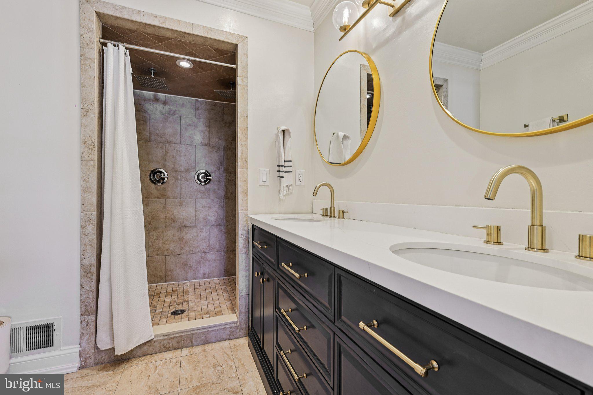 10616 Pennydog Lane Silver Spring, MD 20902 - Photo 20 of 58 a bathroom with a double vanity sink and a mirror