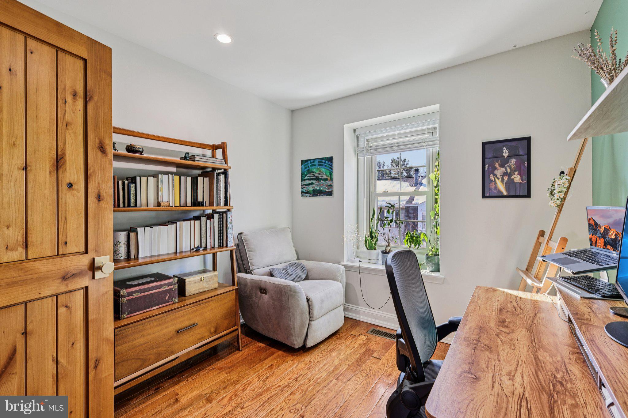 10616 Pennydog Lane Silver Spring, MD 20902 - Photo 23 of 58 a view of a workspace with furniture and book shelf