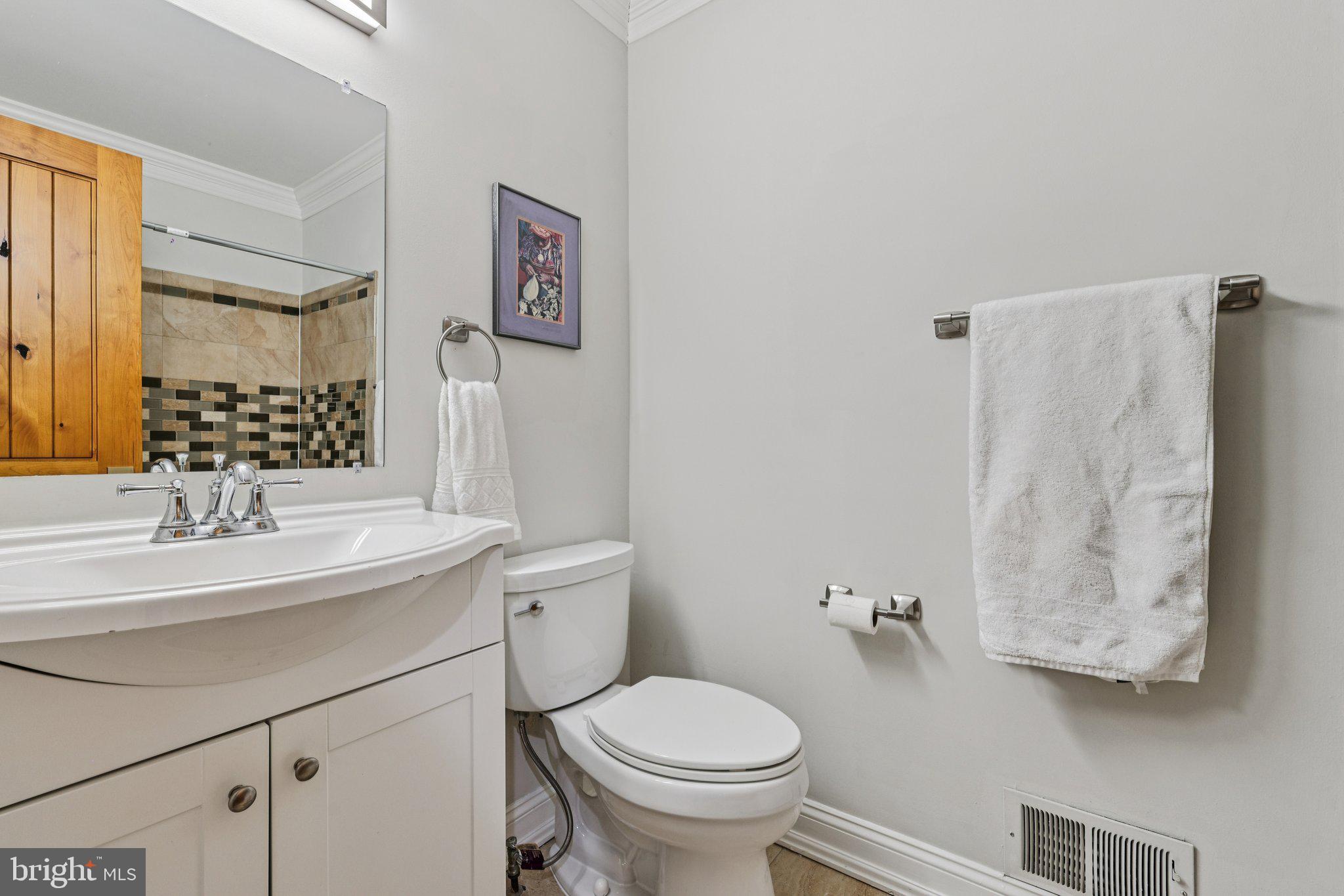 10616 Pennydog Lane Silver Spring, MD 20902 - Photo 24 of 58 a bathroom with a sink toilet and mirror