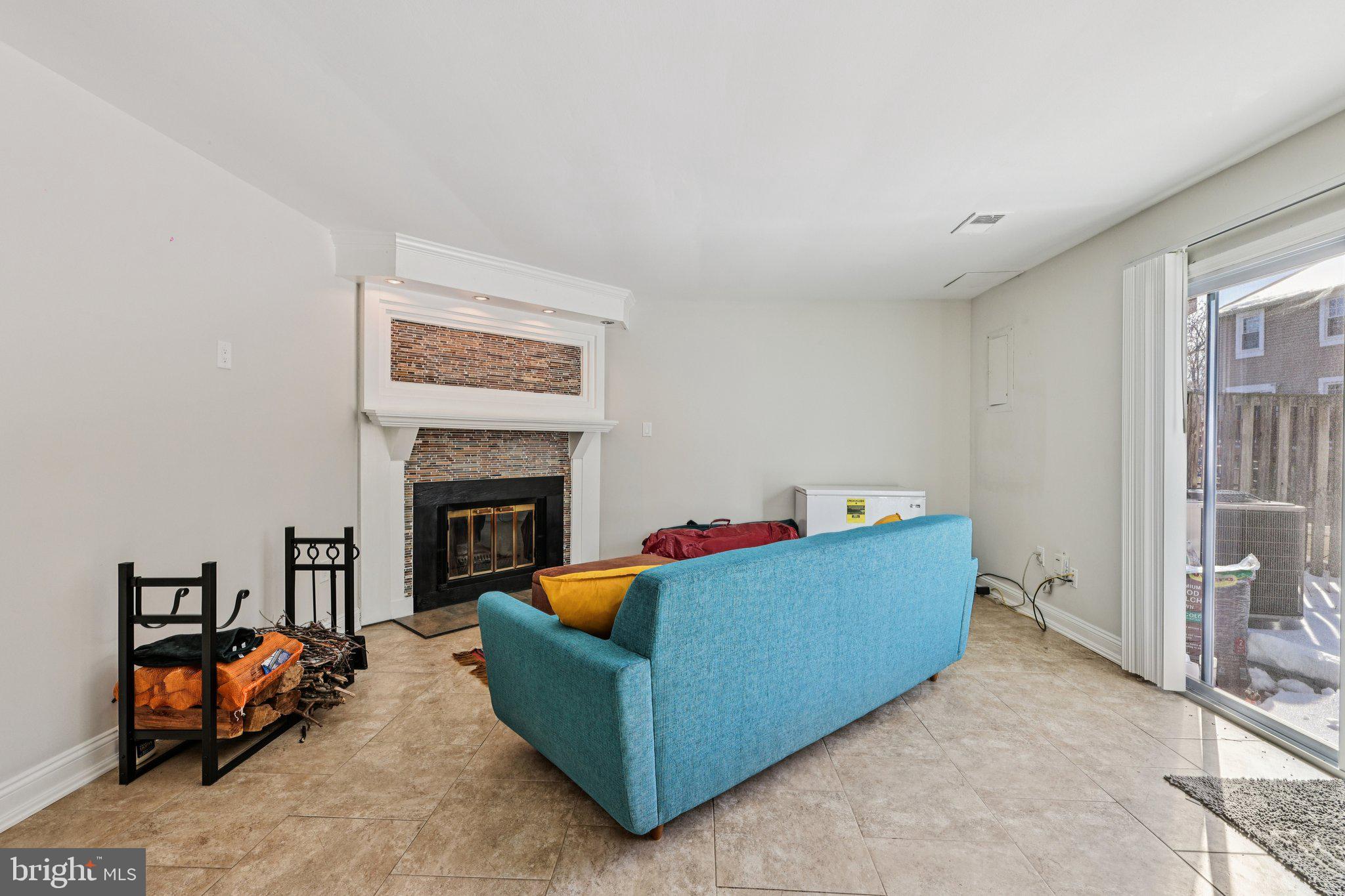 10616 Pennydog Lane Silver Spring, MD 20902 - Photo 29 of 58 a living room with furniture and a fireplace