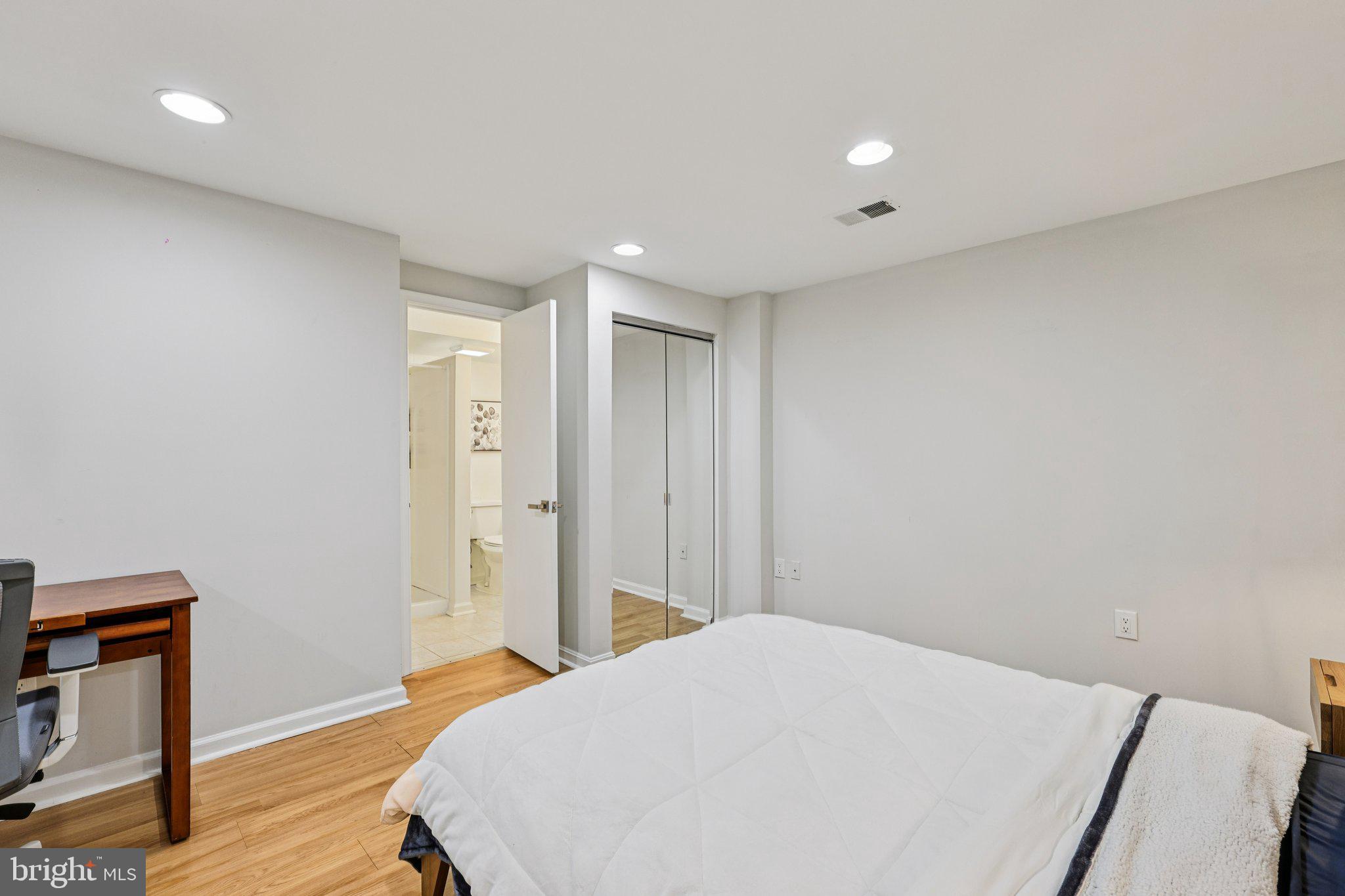 10616 Pennydog Lane Silver Spring, MD 20902 - Photo 36 of 58 a bedroom with a bed and wooden floor