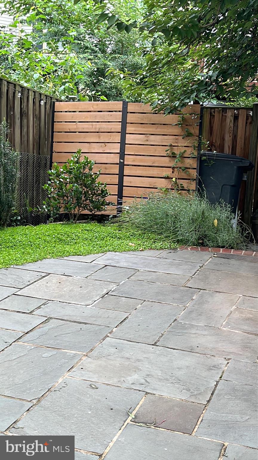 10616 Pennydog Lane Silver Spring, MD 20902 - Photo 45 of 58 a view of a backyard with wooden fence