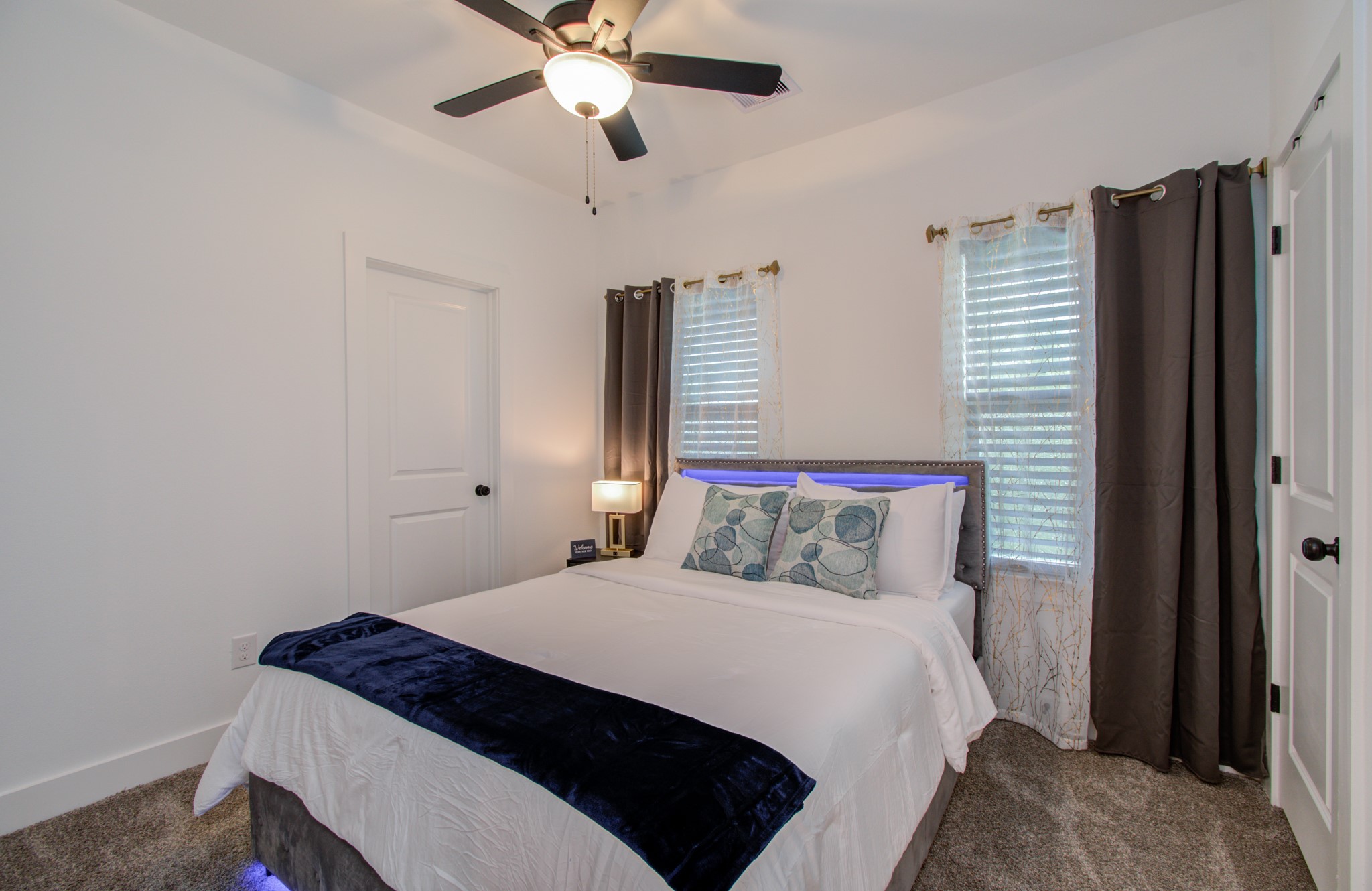 1616 Benson Street Houston, TX 77020 - Photo 28 of 38 a bedroom with a bed and a chandelier