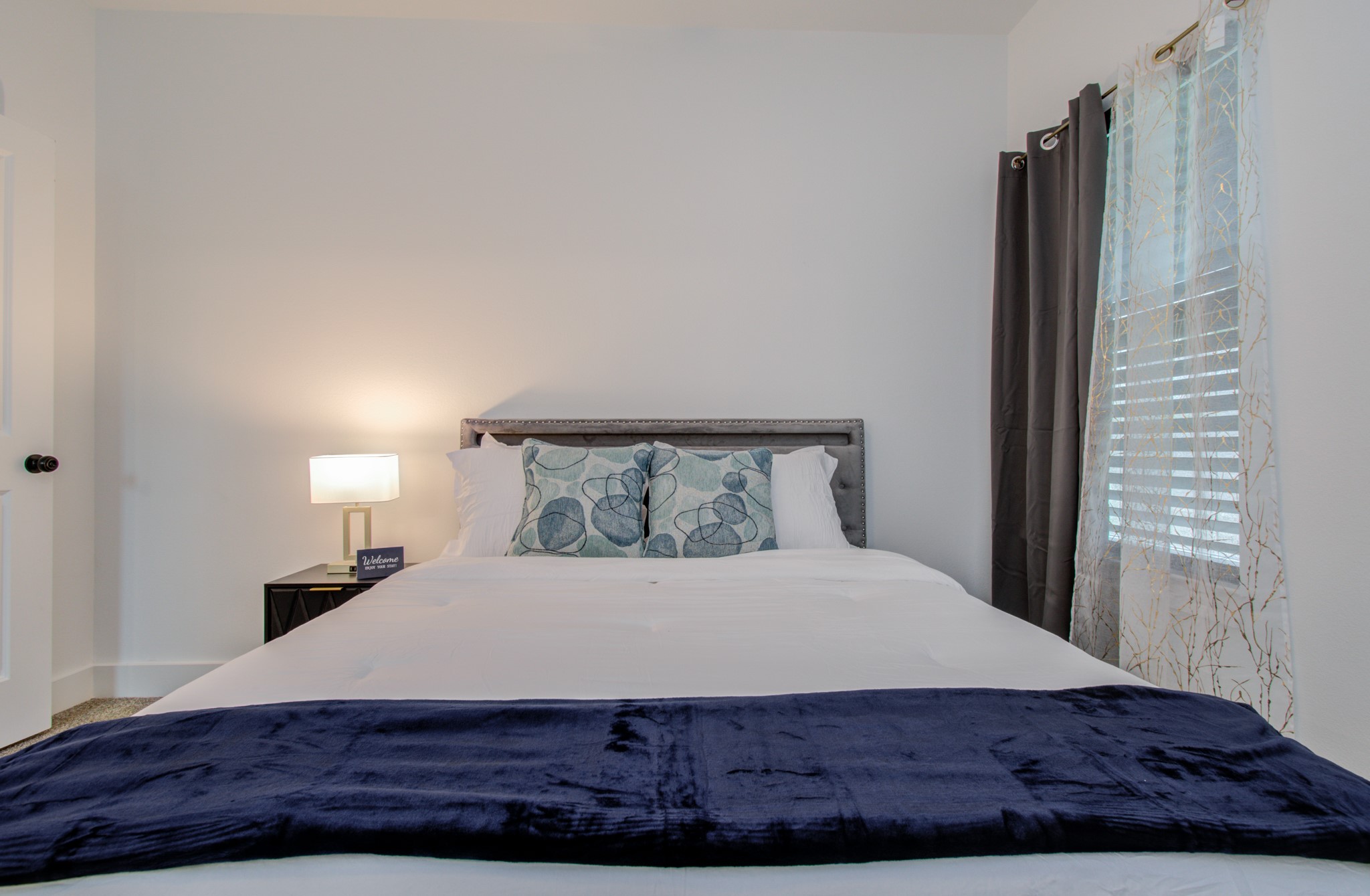 1616 Benson Street Houston, TX 77020 - Photo 30 of 38 a bedroom with a large bed and a potted plant