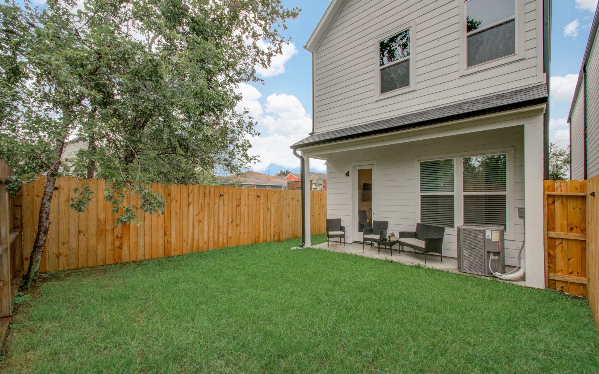 1616 Benson Street Houston, TX 77020 - Photo 36 of 38 a view of a backyard with table and chairs and wooden fence