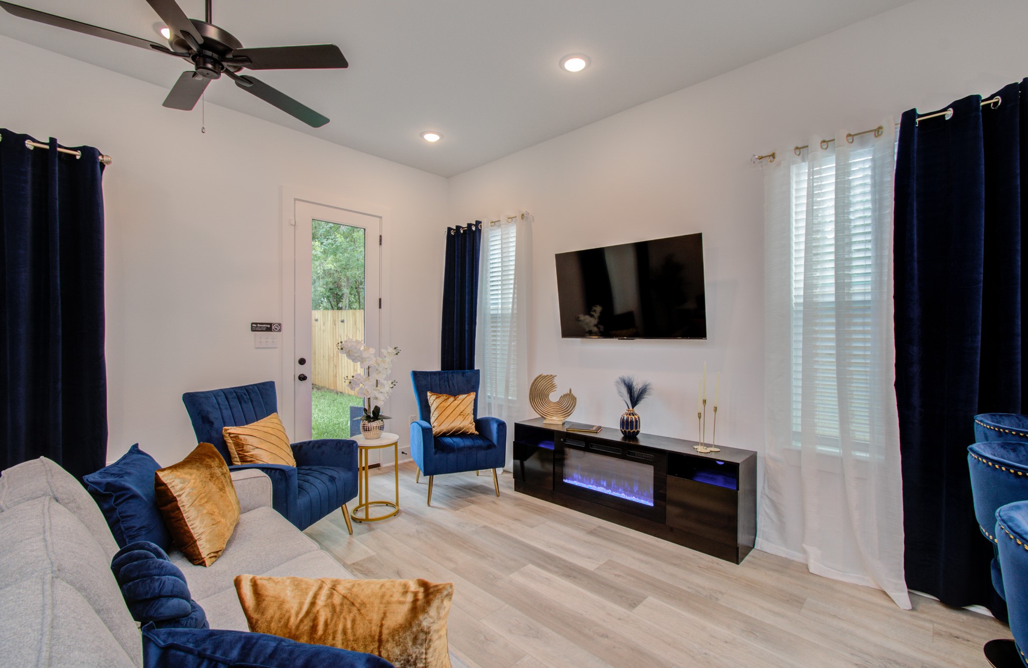 1616 Benson Street Houston, TX 77020 - Photo 9 of 38 a living room with furniture and a flat screen tv
