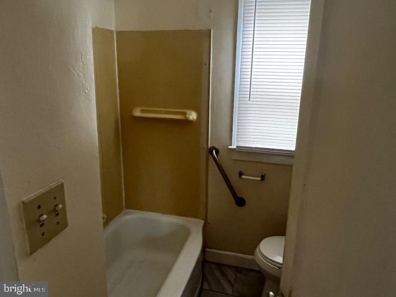 912 Nichols Drive Laurel, MD 20707 - Photo 12 of 14 a bathroom with a granite countertop toilet and a sink