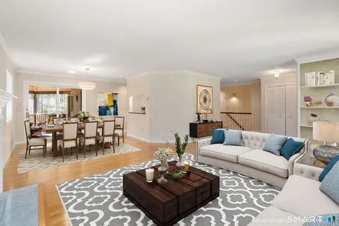 a living room with furniture and wooden floor