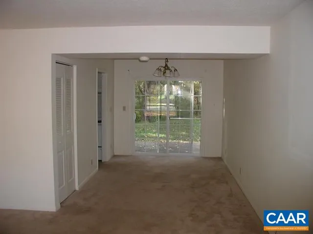 a view of room with window and chandelier