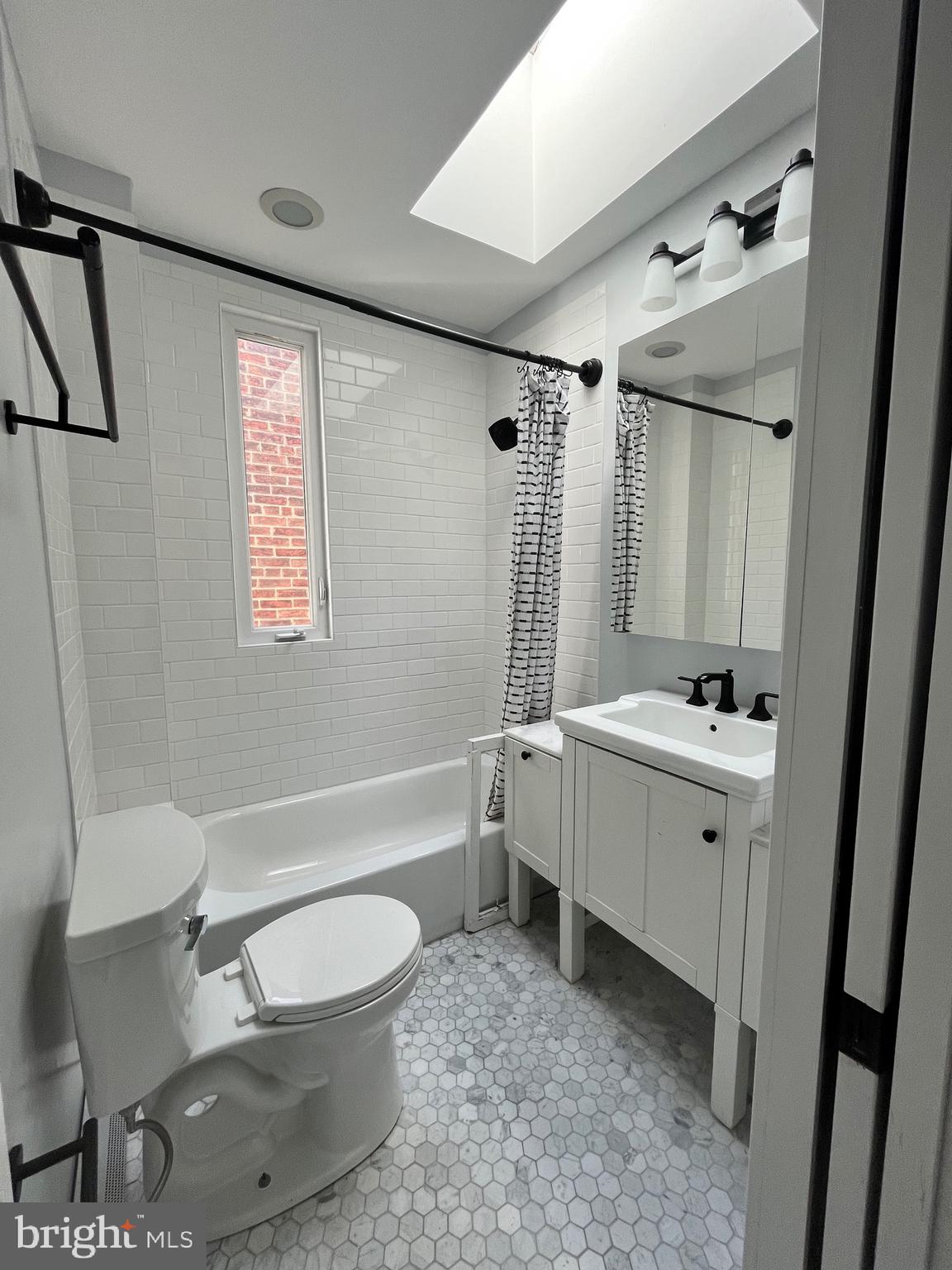 547 4th Street Southeast Washington, DC 20003 - Photo 11 of 13 a bathroom with a double vanity sink toilet mirror and bathtub