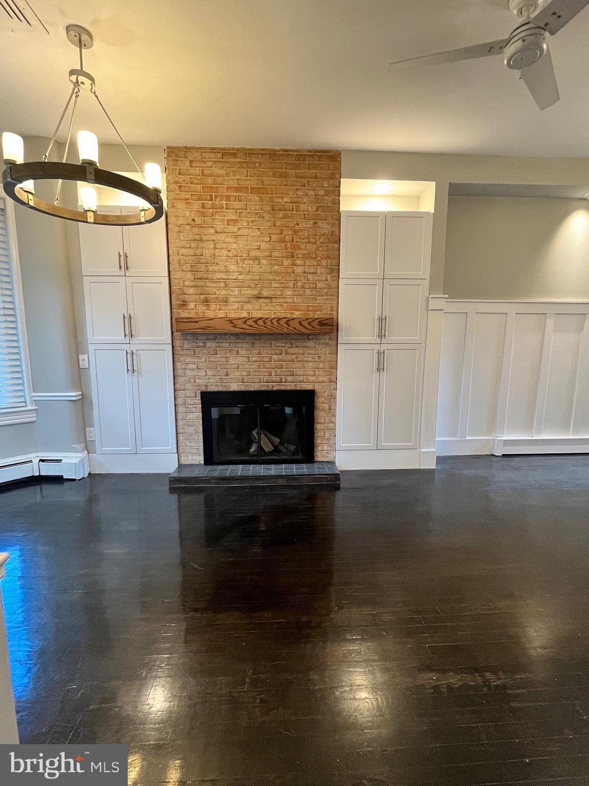547 4th Street Southeast Washington, DC 20003 - Photo 3 of 13 a living room with hard wood floors and a fireplace