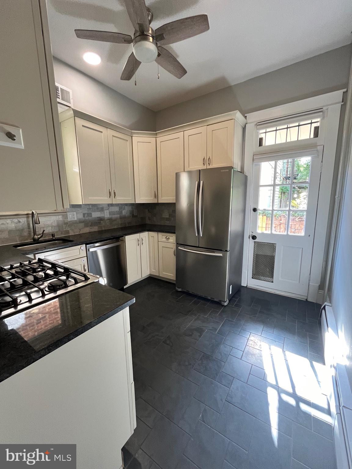 547 4th Street Southeast Washington, DC 20003 - Photo 4 of 13 a kitchen with stainless steel appliances a refrigerator a stove a sink and a window