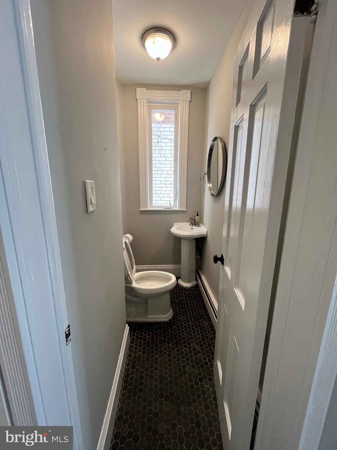 547 4th Street Southeast Washington, DC 20003 - Photo 6 of 13 a bathroom with a sink a toilet and a mirror