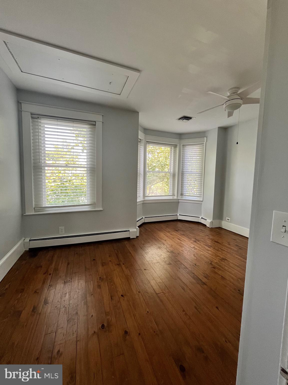 547 4th Street Southeast Washington, DC 20003 - Photo 8 of 13 an empty room with wooden floor and windows