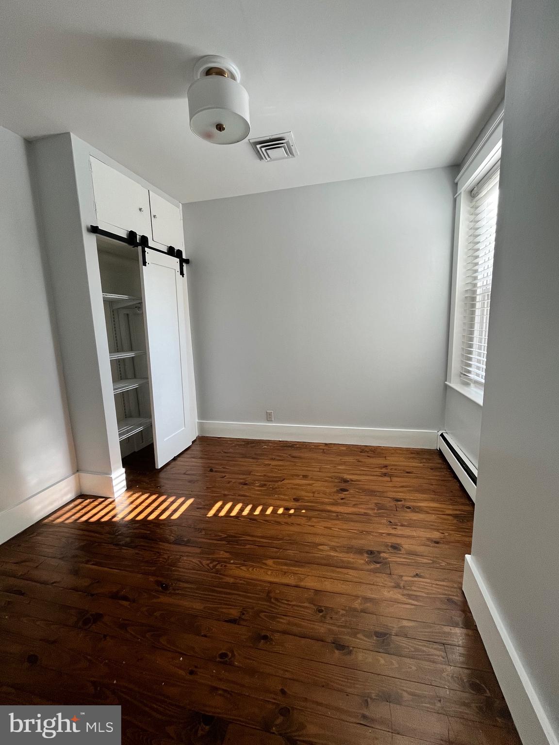 547 4th Street Southeast Washington, DC 20003 - Photo 9 of 13 a view of an empty room with wooden floor and a window