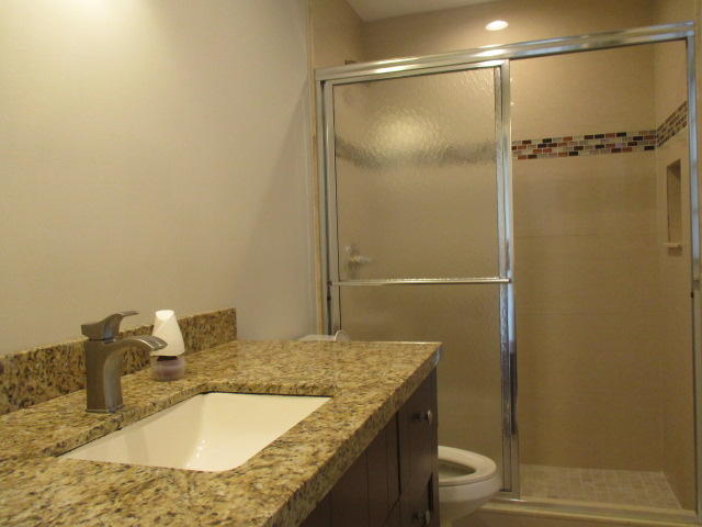 8904 Southwest 16th Street Boca Raton, FL 33433 - Photo 12 of 29 a bathroom with a granite countertop sink toilet and shower
