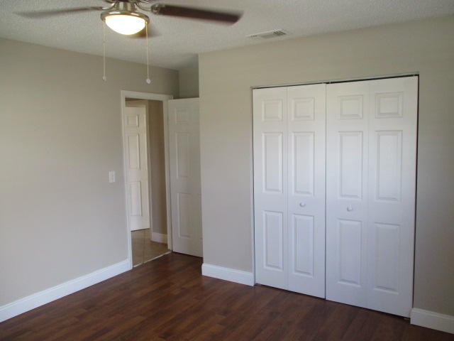 8904 Southwest 16th Street Boca Raton, FL 33433 - Photo 15 of 29 an empty room with wooden floor and closet area