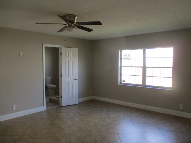 8904 Southwest 16th Street Boca Raton, FL 33433 - Photo 16 of 29 an empty room with a window and a ceiling fan