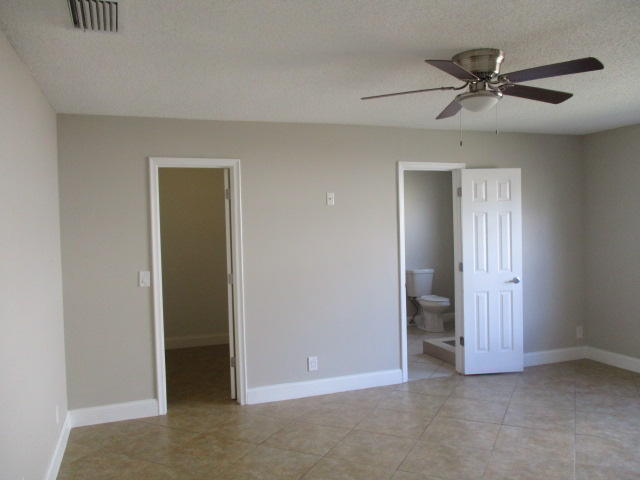 8904 Southwest 16th Street Boca Raton, FL 33433 - Photo 17 of 29 an empty room with a ceiling fan and a window