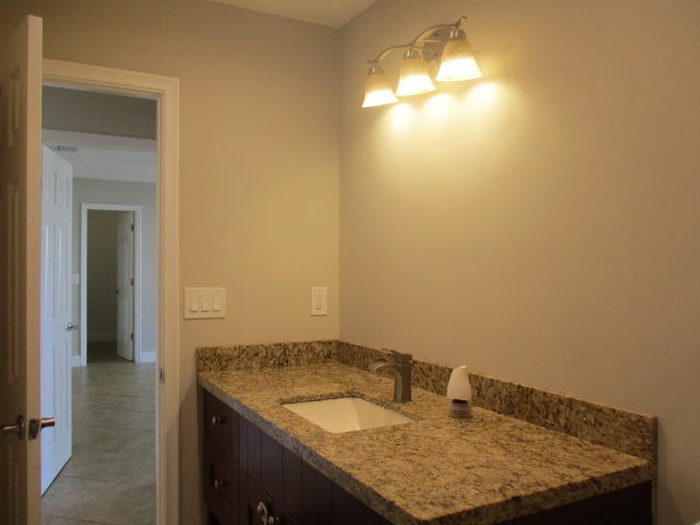 8904 Southwest 16th Street Boca Raton, FL 33433 - Photo 24 of 29 a bathroom with a granite countertop sink and a mirror
