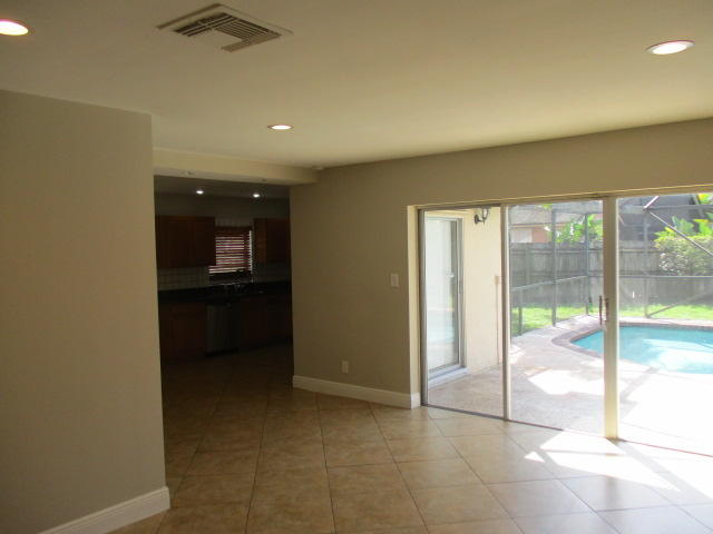 8904 Southwest 16th Street Boca Raton, FL 33433 - Photo 6 of 29 a view of a hallway with an empty room and floor to ceiling window