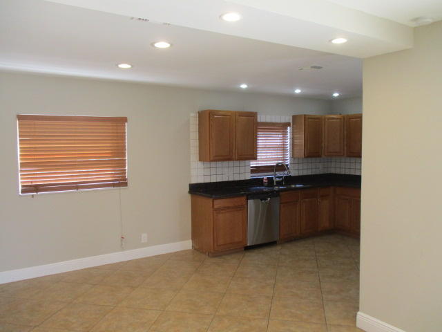 8904 Southwest 16th Street Boca Raton, FL 33433 - Photo 7 of 29 a kitchen with granite countertop a stove a sink and a microwave