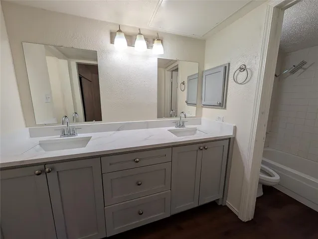 a bathroom with double vanity sink and a mirror