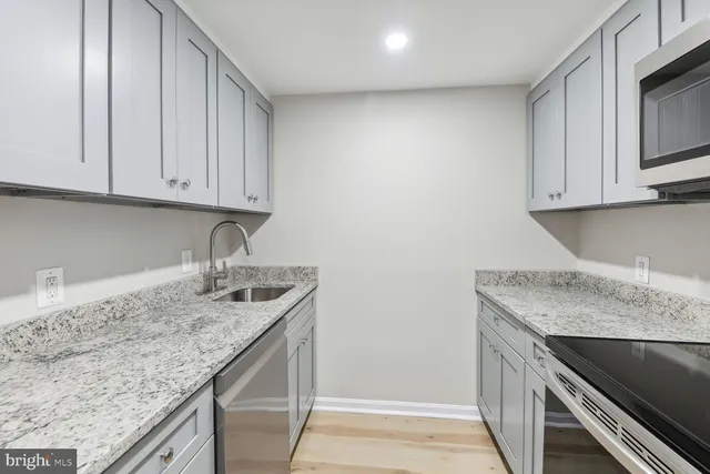 a stove top oven sitting inside of a kitchen