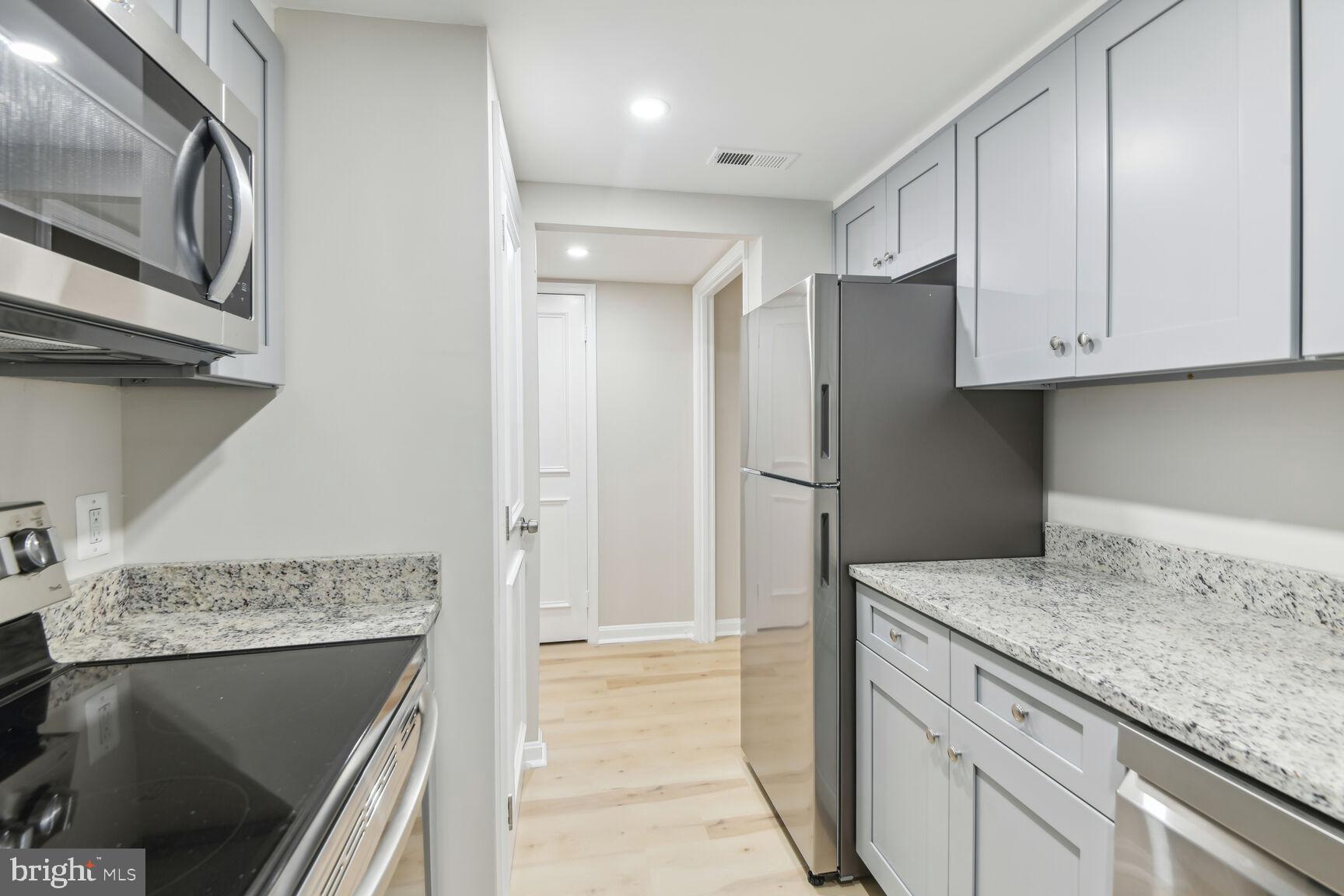 327-329 8th Street Northeast, Unit 9 Washington, DC 20002 - Photo 7 of 28 a kitchen with stainless steel appliances granite countertop a refrigerator and a sink