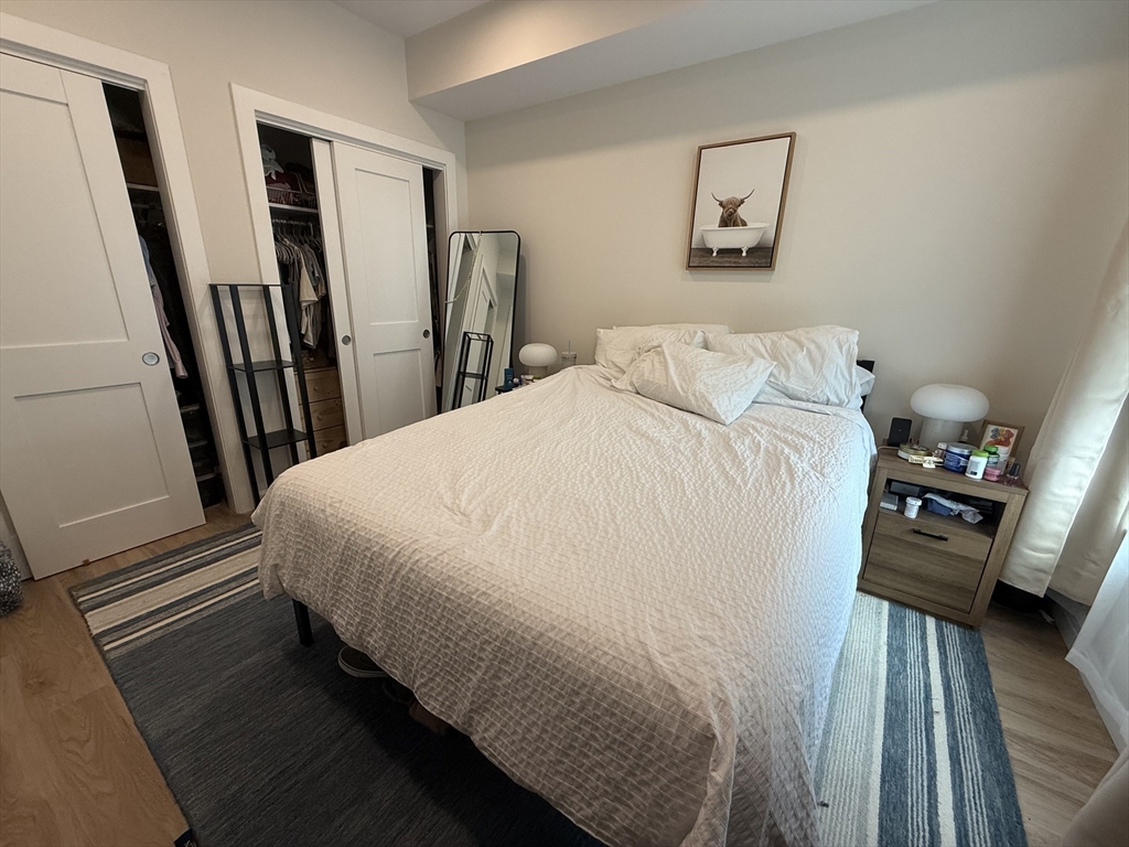 458 Washington Street, Unit 308 Boston, MA 02135 - Photo 6 of 14 a bed sitting in a bedroom next to a window