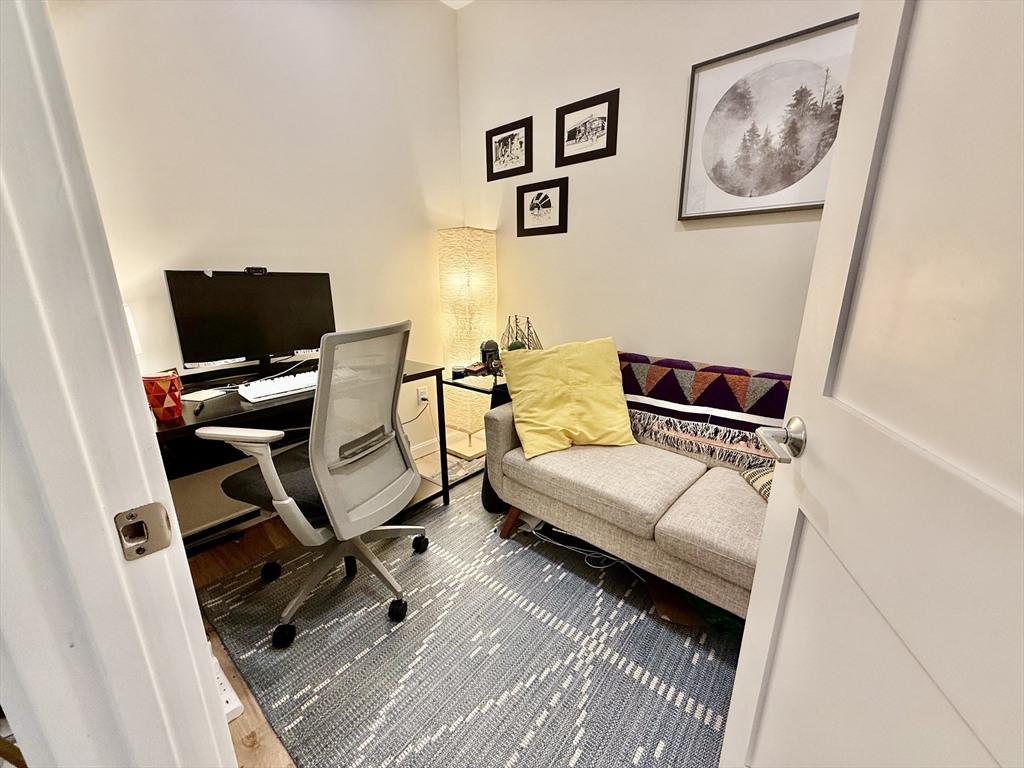 458 Washington Street, Unit 308 Boston, MA 02135 - Photo 7 of 14 a living room with furniture and wooden floor