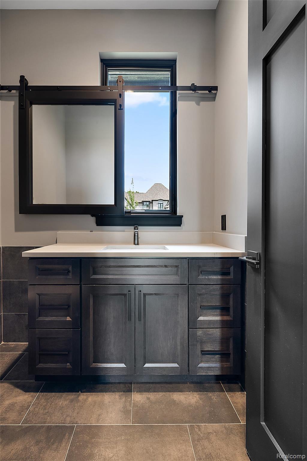 5541 Bordman Road Dryden, MI 48428 - Photo 10 of 27 Bathroom featuring vanity and dark tile patterned floors