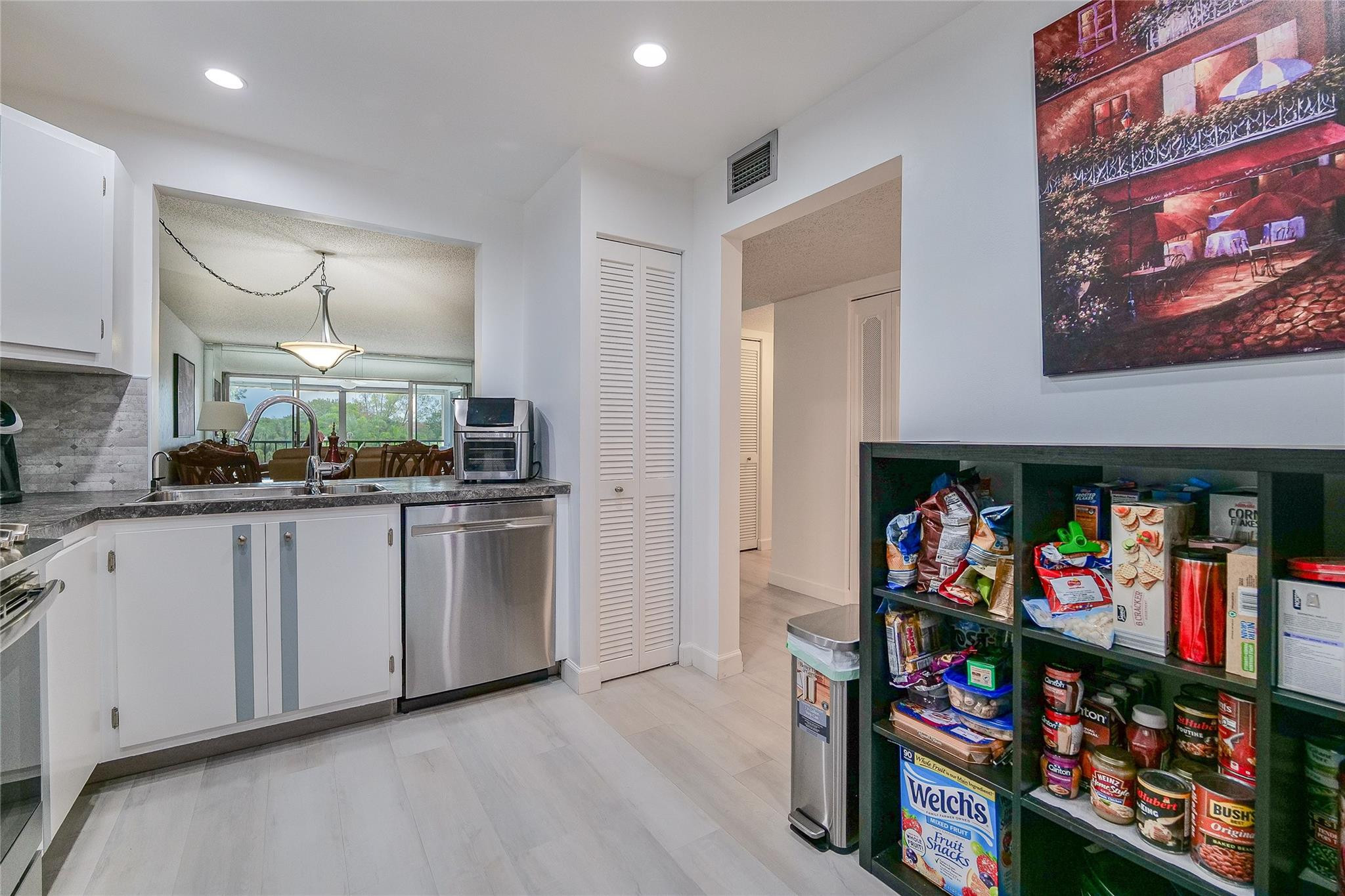 3930 Inverrary Boulevard, Unit 407D Lauderhill, FL 33319 - Photo 12 of 60 a kitchen with stainless steel appliances granite countertop a refrigerator and a stove top oven