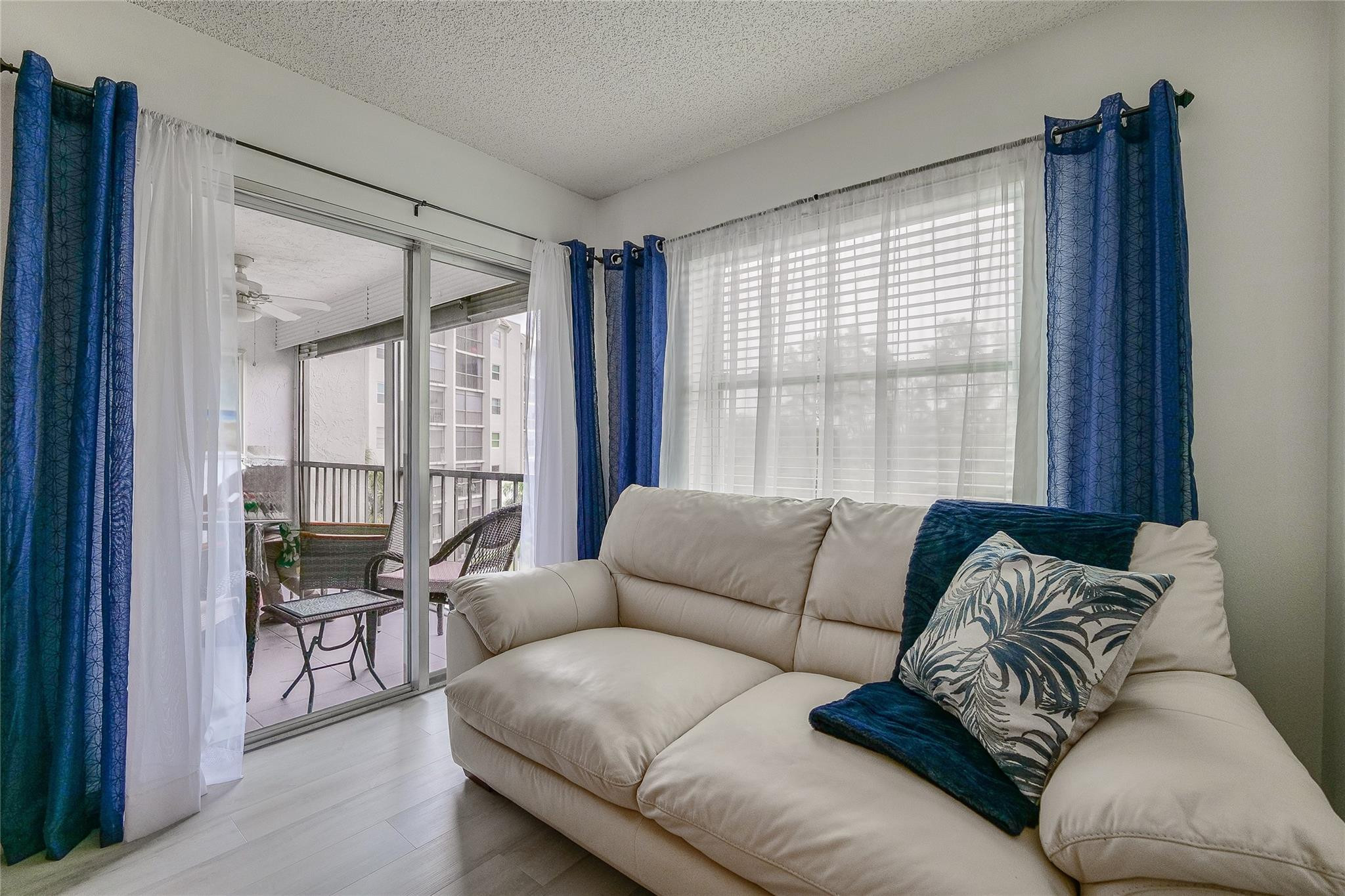 3930 Inverrary Boulevard, Unit 407D Lauderhill, FL 33319 - Photo 16 of 60 a living room with furniture and a large window