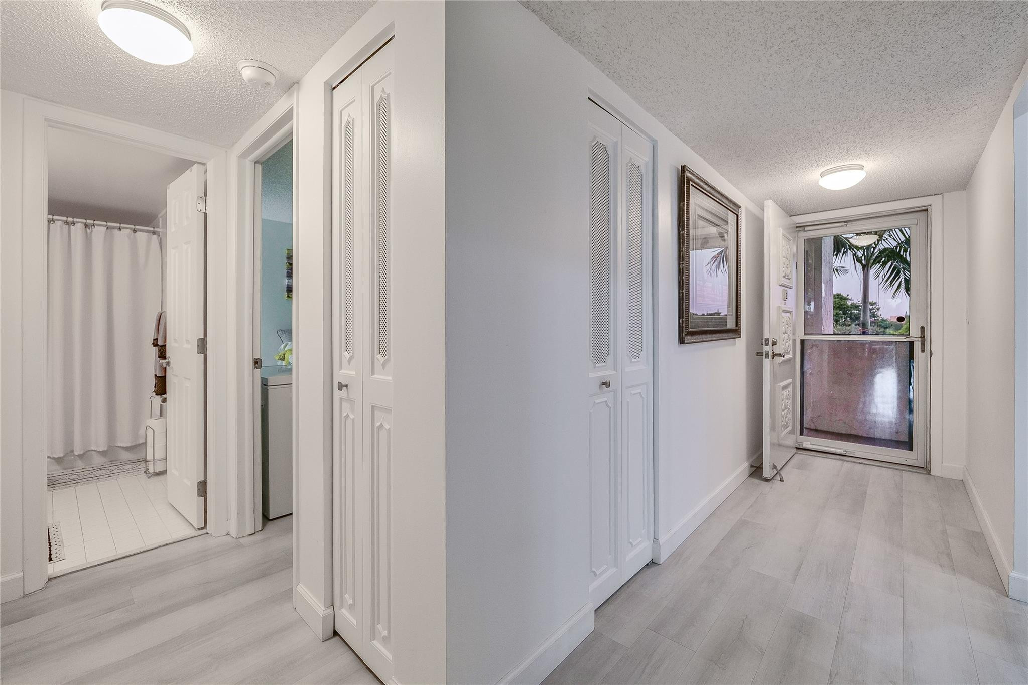 3930 Inverrary Boulevard, Unit 407D Lauderhill, FL 33319 - Photo 23 of 60 a view of hallway with wooden floor and cabinet