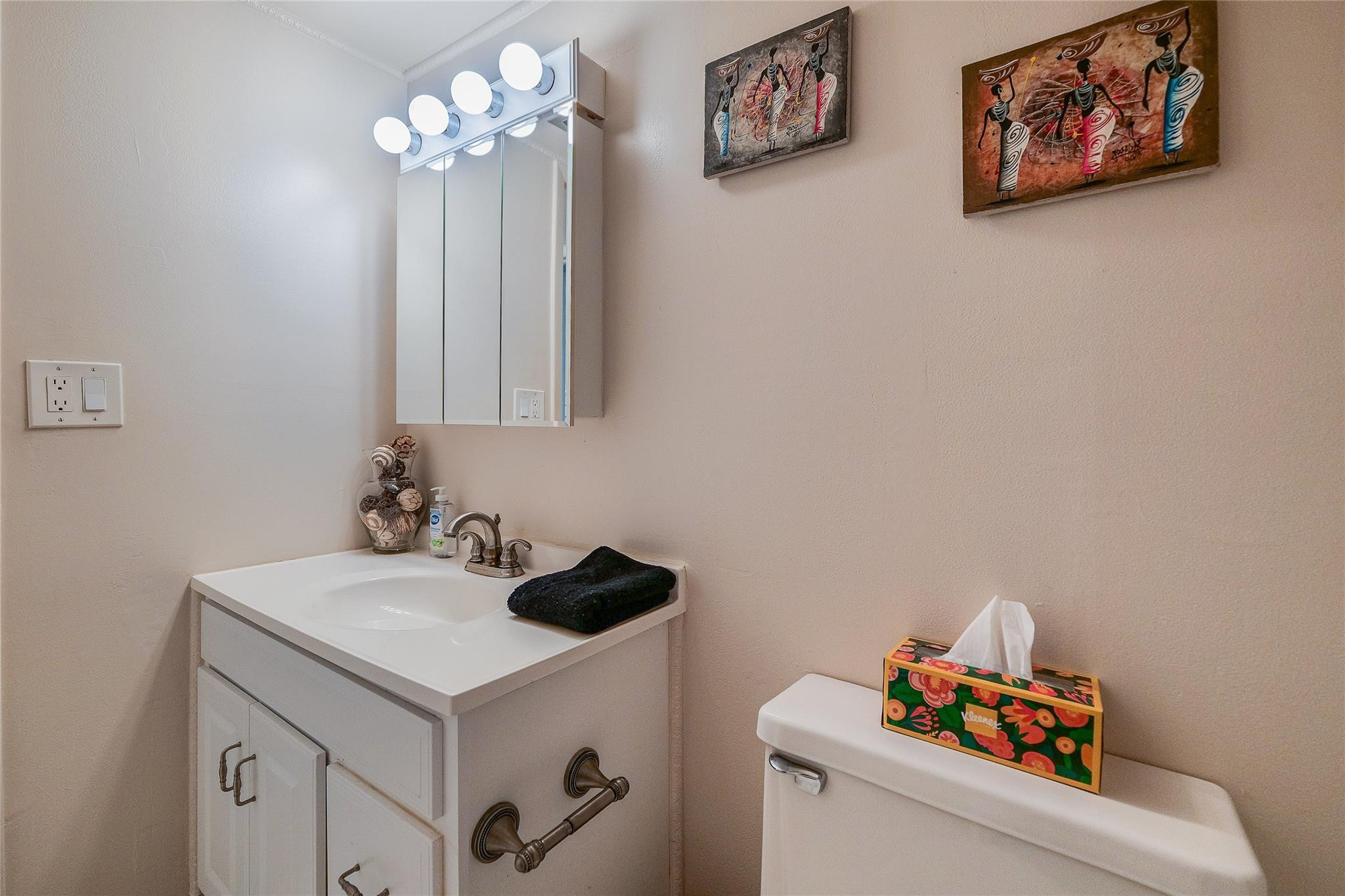 3930 Inverrary Boulevard, Unit 407D Lauderhill, FL 33319 - Photo 27 of 60 a bathroom with a sink and a stove with white cabinet