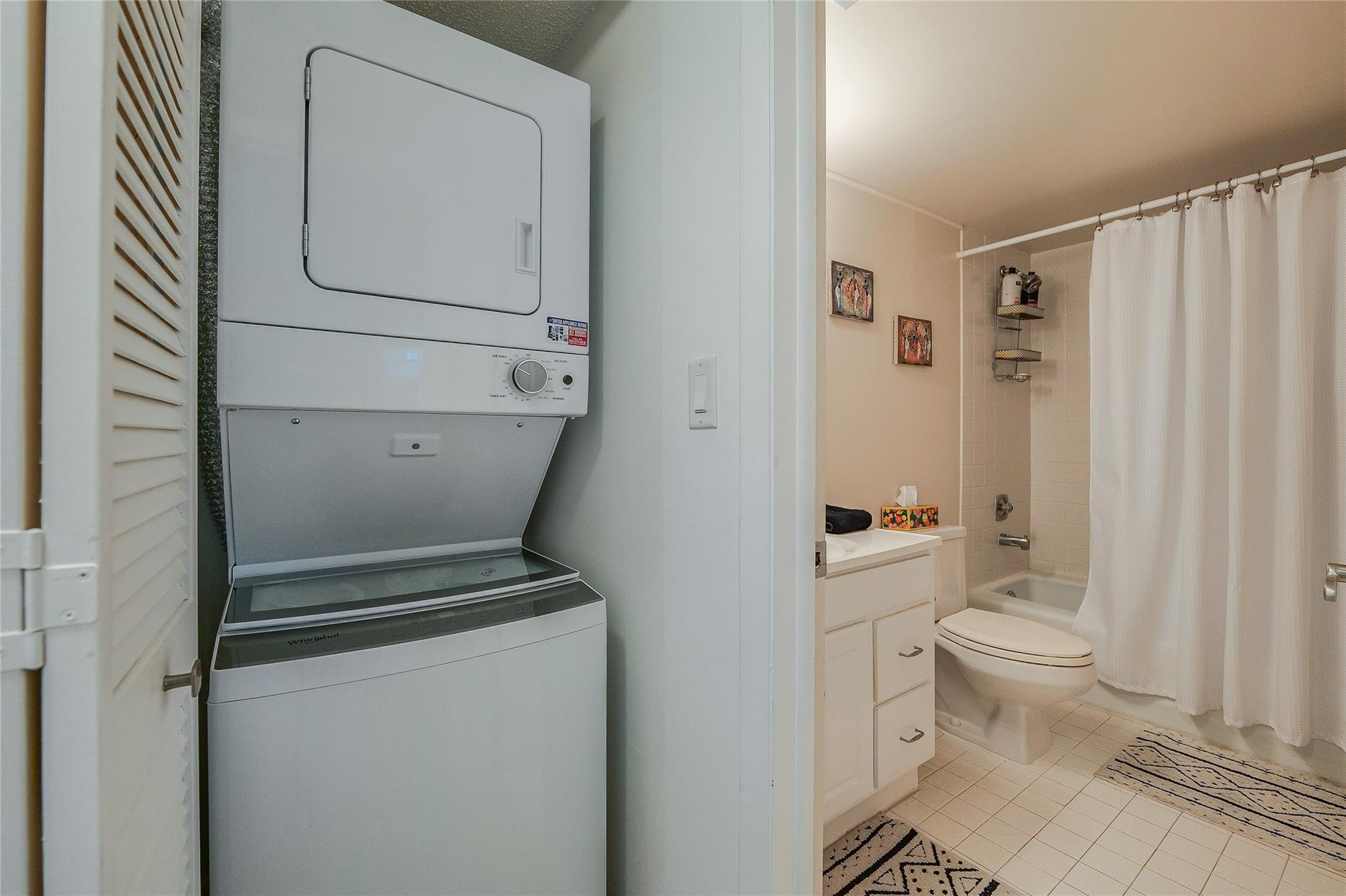 3930 Inverrary Boulevard, Unit 407D Lauderhill, FL 33319 - Photo 29 of 60 a bathroom with a toilet and a shower curtain