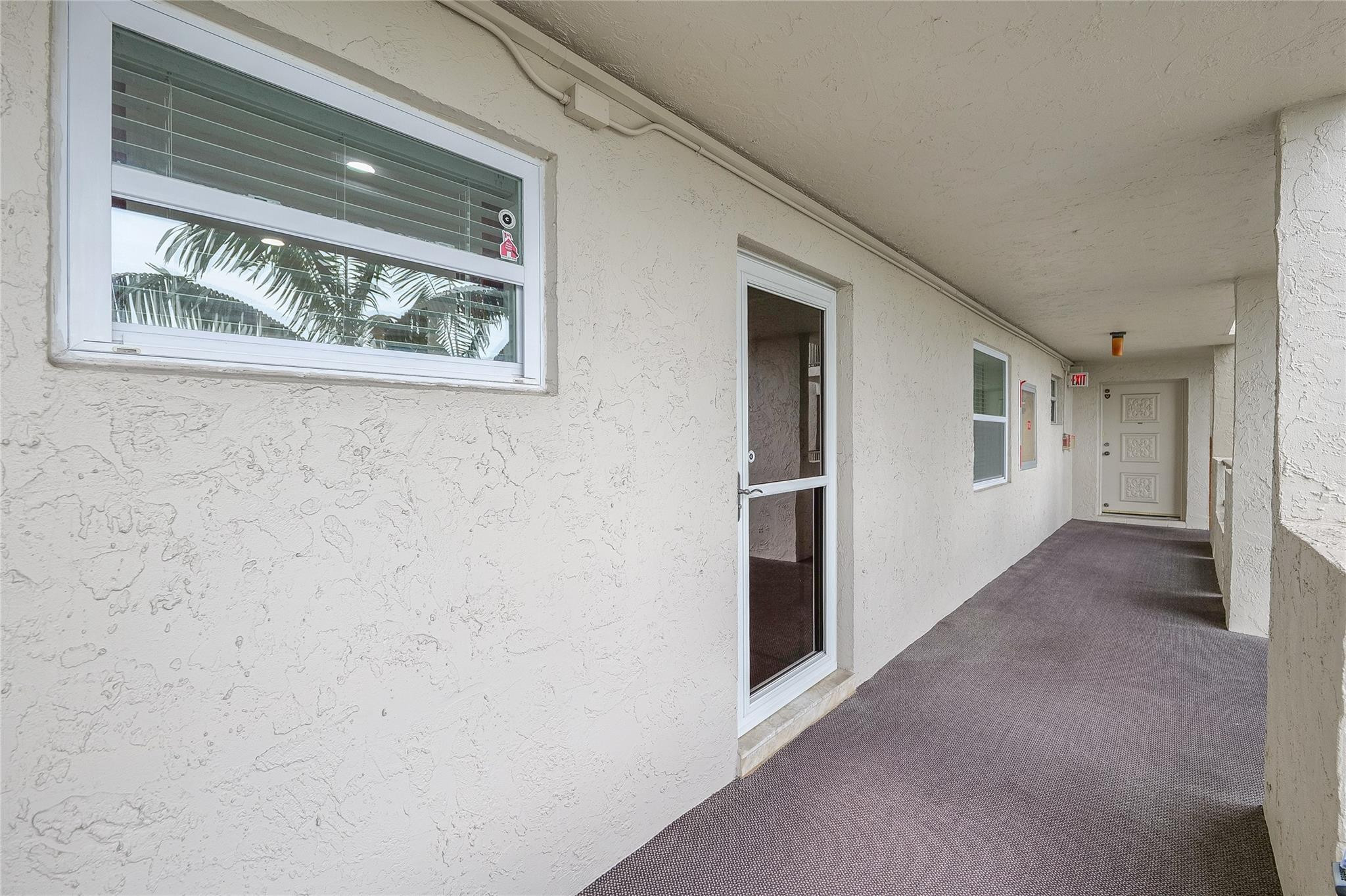 3930 Inverrary Boulevard, Unit 407D Lauderhill, FL 33319 - Photo 31 of 60 a view of a hallway with wooden floor and a window