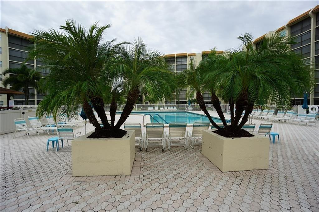 3930 Inverrary Boulevard, Unit 407D Lauderhill, FL 33319 - Photo 37 of 60 a view of a water fountain and a palm tree