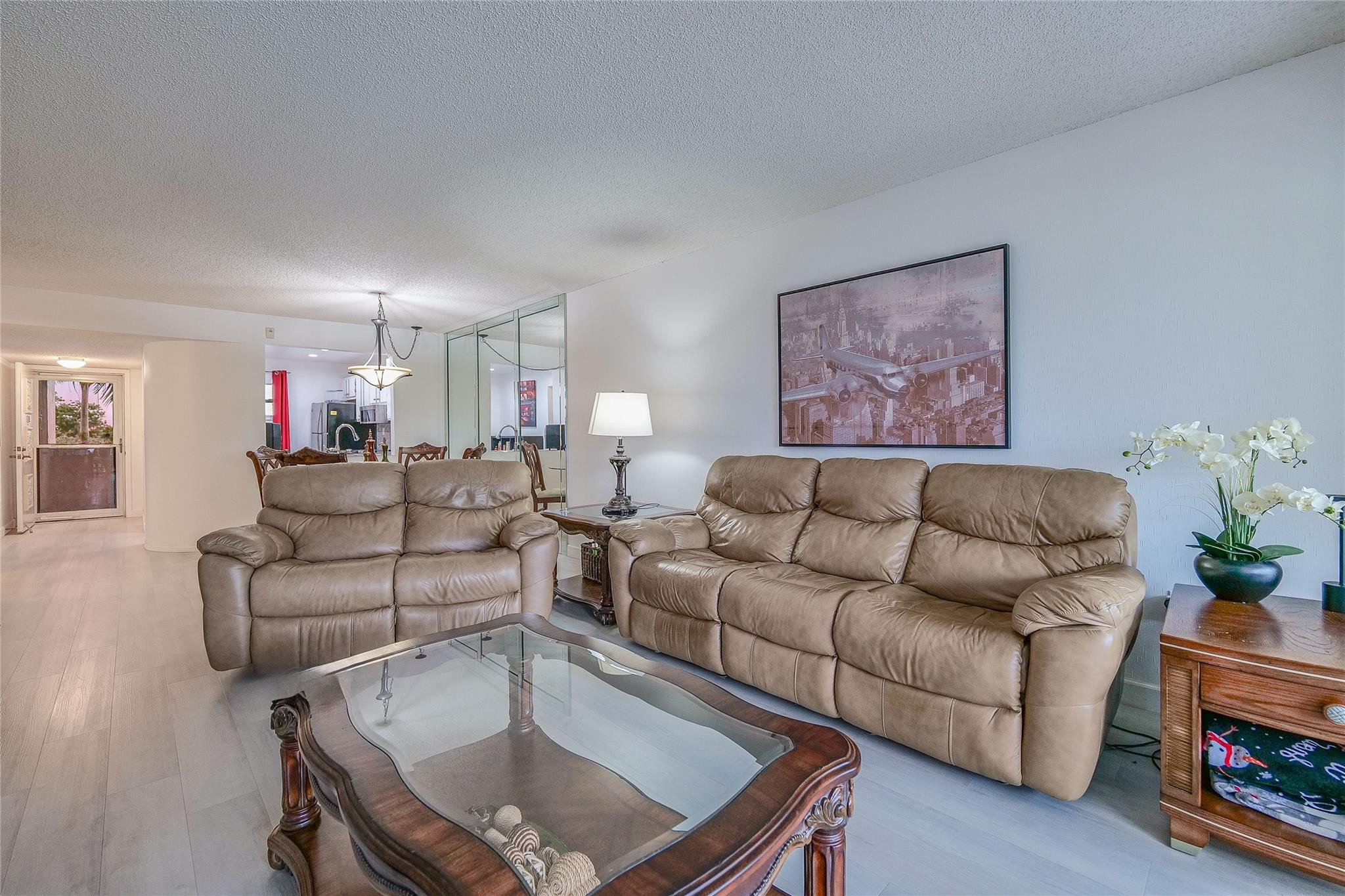 3930 Inverrary Boulevard, Unit 407D Lauderhill, FL 33319 - Photo 8 of 60 a living room with furniture and a wooden floor