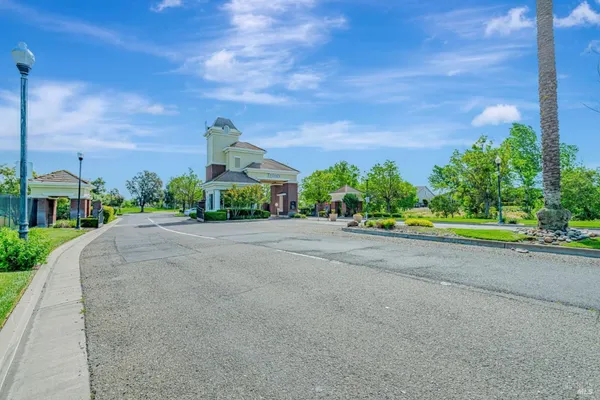a front view of a house with a yard and a road