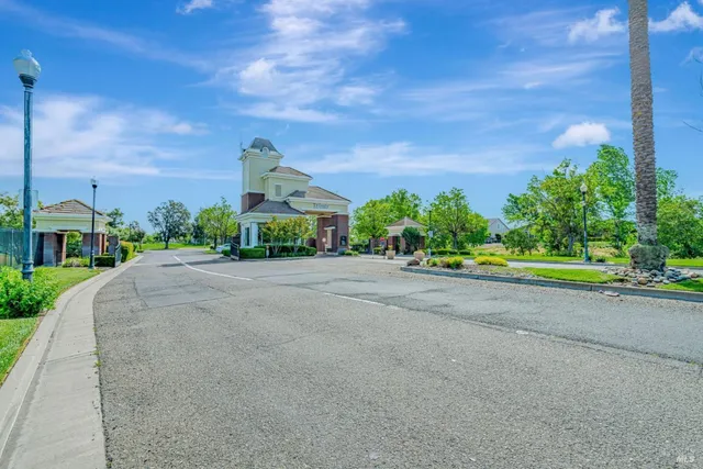 a front view of a house with a yard and a road