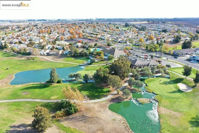 an aerial view of a house with a yard swimming pool and outdoor seating