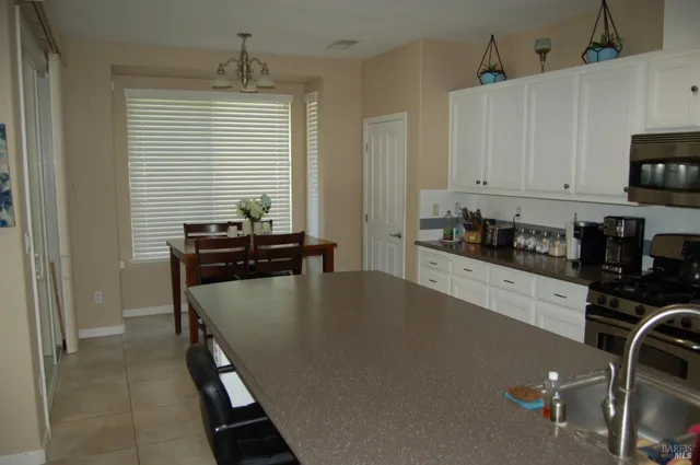 a kitchen with a table chairs and a refrigerator