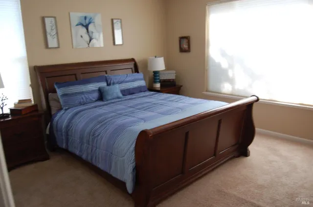 a bedroom with a bed and window