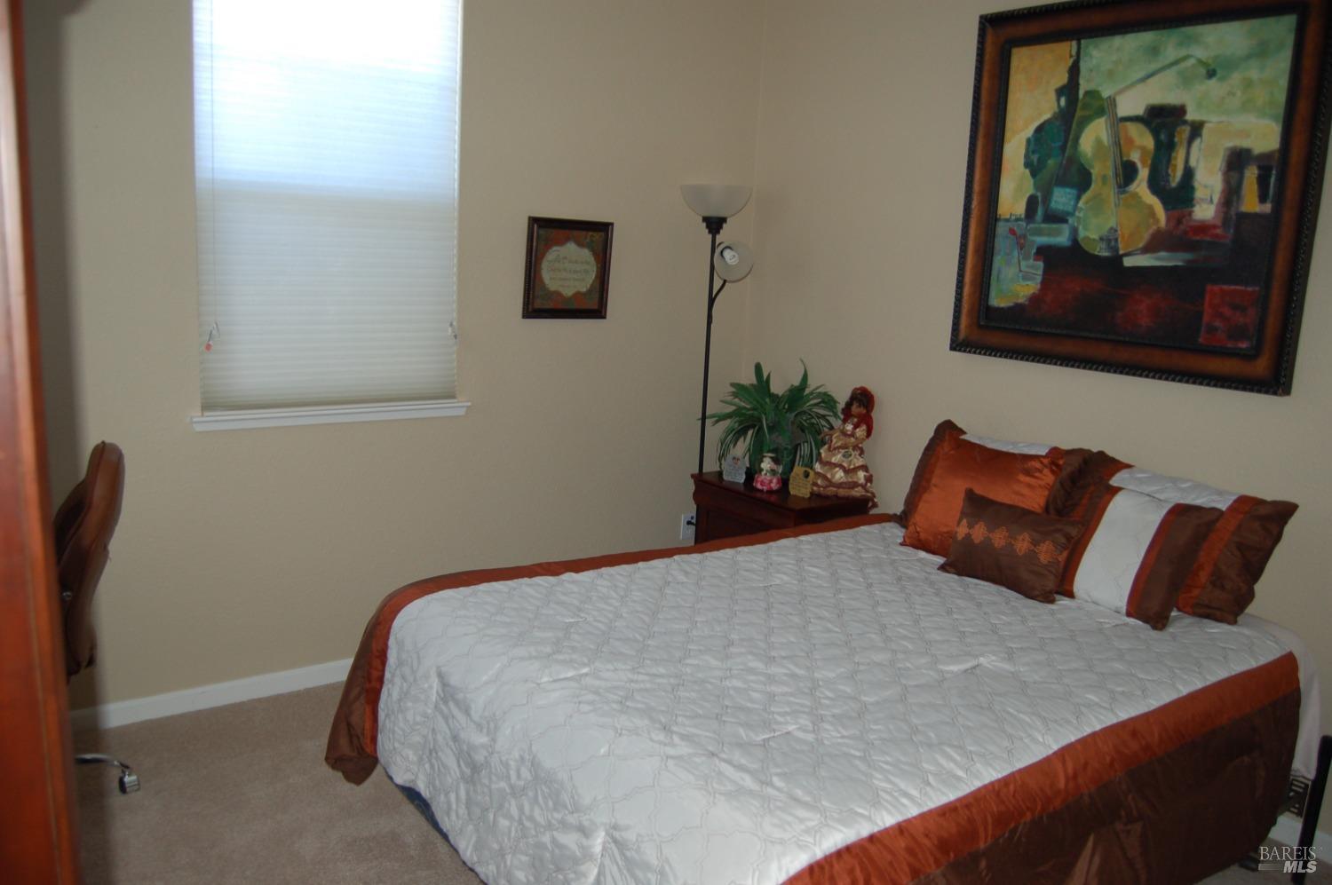 402 Palisades Drive Rio Vista, CA 94571 - Photo 7 of 12 a bedroom with a bed and painting on the wall