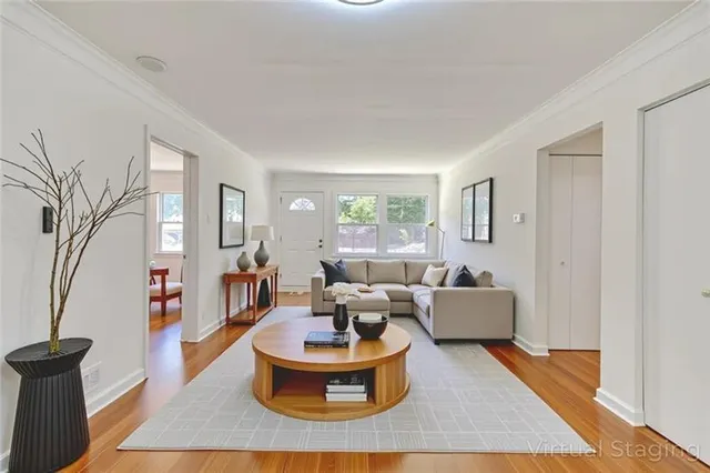 a living room with fireplace furniture and a rug