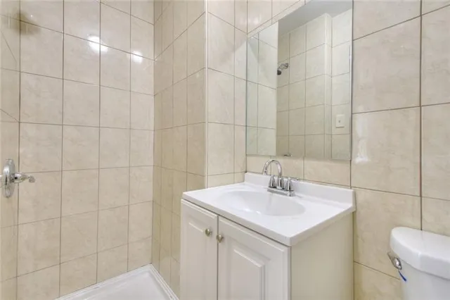 a bathroom with a sink shower and toilet