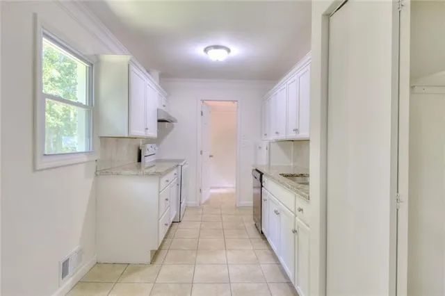 a kitchen with a sink and a stove top oven