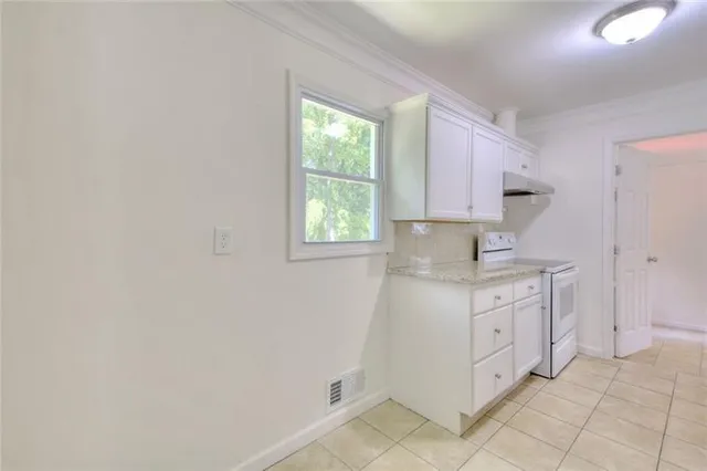a spacious bathroom with a granite countertop sink a mirror and a vanity